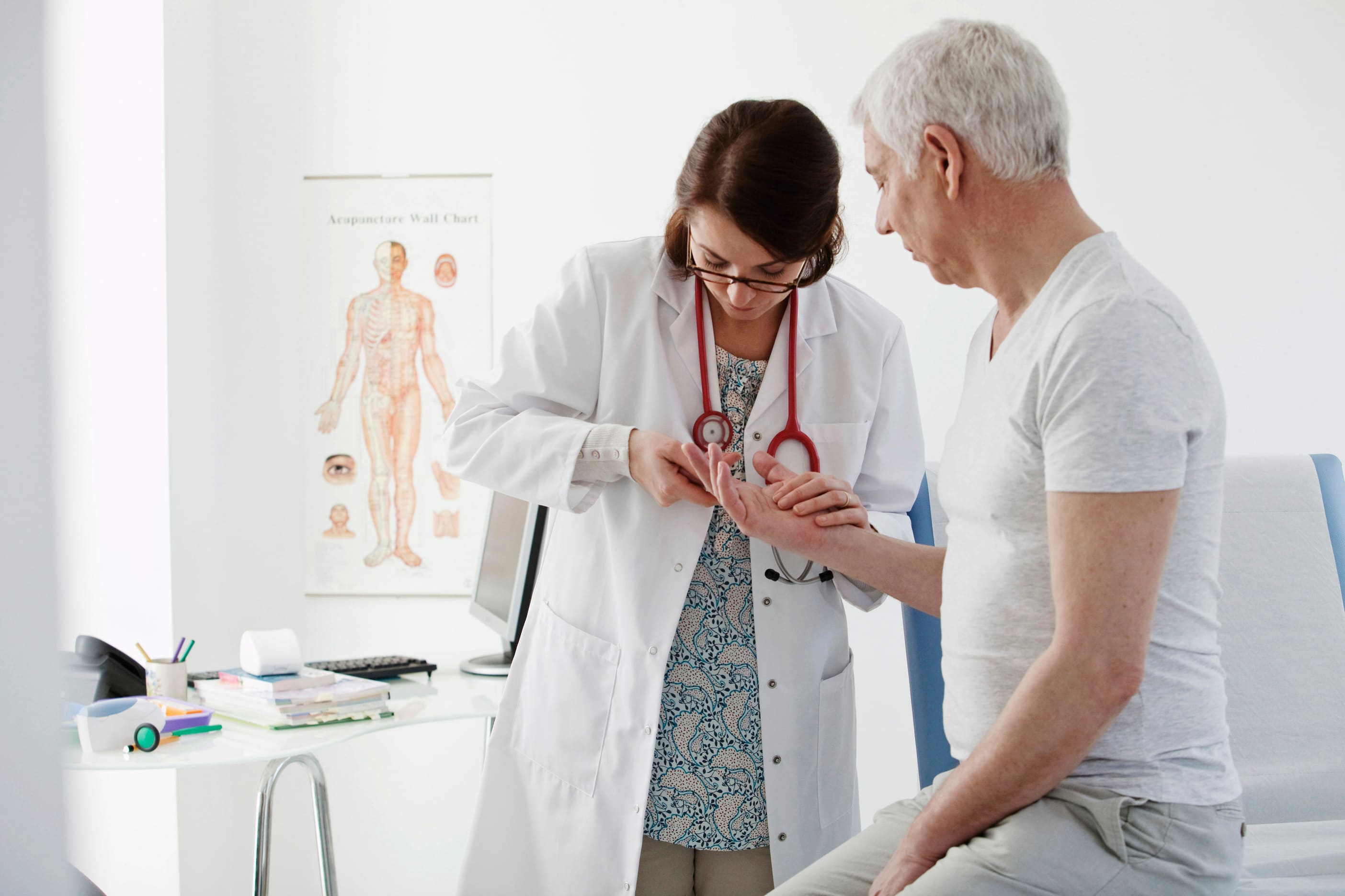 Raynaud’s phenomenon - Doctor looking at patient’s fingers